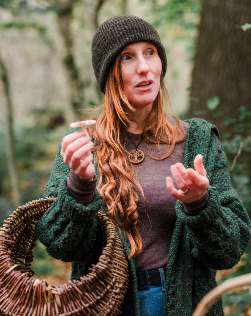 Bex Northman, forager and founder of Wild & Weeds, holding a foraging basket in the woods